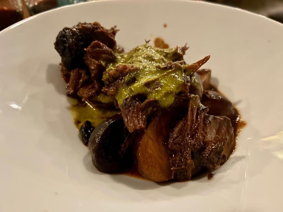 Amilinda's braised beef cheeks are served with roasted marble potatoes and a vibrant chimichurri sauce.