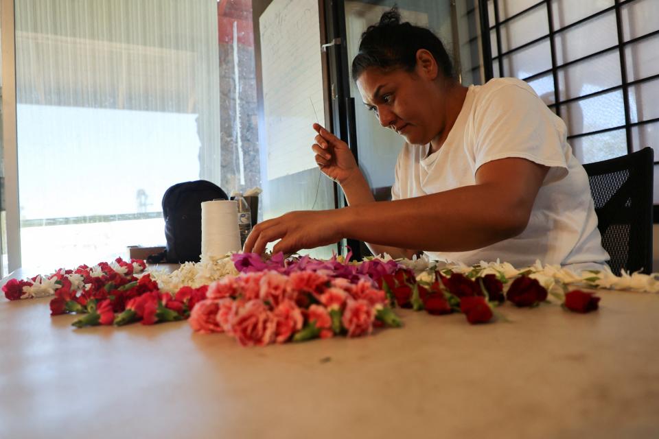 A worker at Maui Floral makes a lei, a traditional Hawaiian symbol that has taken on added significance in times of grief for the community of Lahaina in Makawao, Hawaii, (REUTERS)