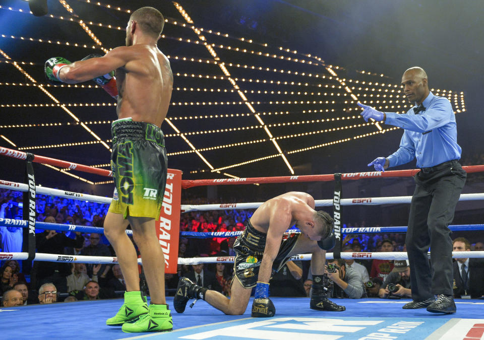 Vasiliy Lomachenko heads to a neutral corner after a second knockdown of Jose Pedraza in the 11th round of the WBO title lightweight boxing match at Madison Square Garden, Saturday, Dec. 8, 2018, in New York. (AP Photo/Howard Simmons)