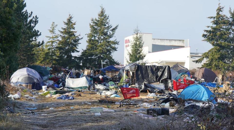 Tents and temporary shelters occupy the property at 4049 Deemer Road near WinCo Foods on Friday, Dec. 16, 2022, in Bellingham, Wash. The city of Bellingham sued the property owner for allegedly causing a public nuisance by not clearing the encampment on the property. Rachel Showalter/The Bellingham Herald