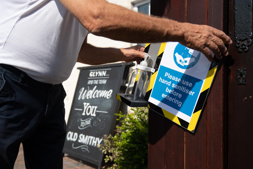 Phil Weaver, owner of The Old Smith in Church Lawford, Warwickshire installs hand sanitising stations, as pub and hospitality bosses have cheered the Government's proposals to allow customers through their doors again on July 4 as "a welcome relief".