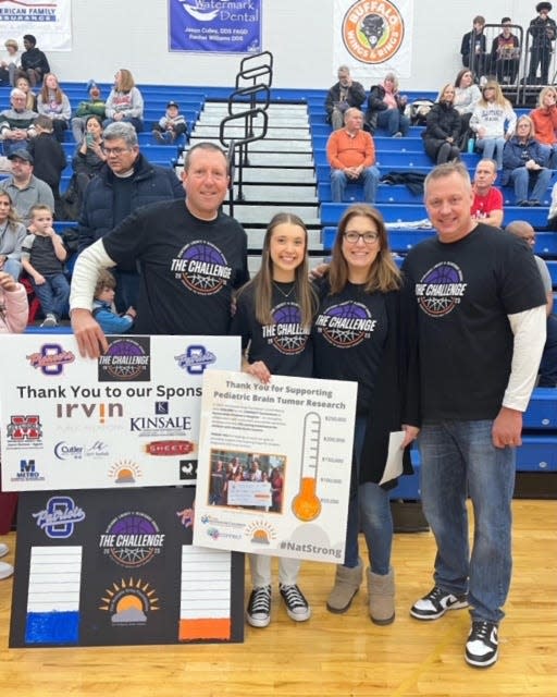 Olentangy Liberty student Natalie Gray is flanked by Natalie Gray Foundation board President Chris Marston (left) and foundation board members Melanie Farkas and Shawn Wagner. The foundation raises money for research and funding to treat pediatric brain cancer.