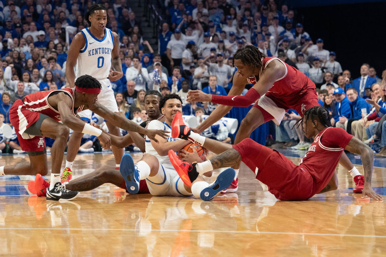 Kentucky Wildcats forward Tre Mitchell (4) fights against the Arkansas Razorbacks during a jump ball during their game on Saturday, March 2, 2024 at Rupp Arena.