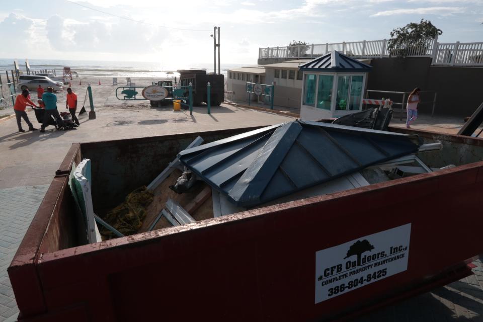 The remnants of a toll booth can be seen in a dumpster at the International Speedway Boulevard beach approach on Monday. On Sunday afternoon, a car careened through the area, injuring four people, including a child.