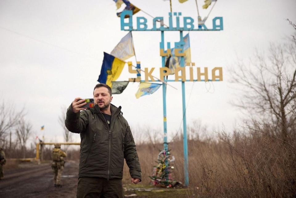 Ukraine’s President Volodymyr Zelensky takes a video in front of a road sign with the words ‘Avdiivka this is Ukraine’ (Ukrainian Presidential Press Service)