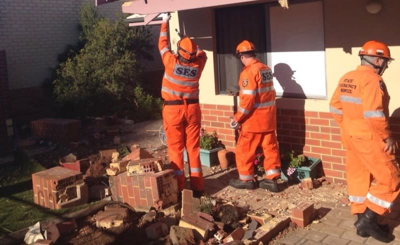 SES workers clean up the front yard. Picture: Simon Hydzik/Seven News