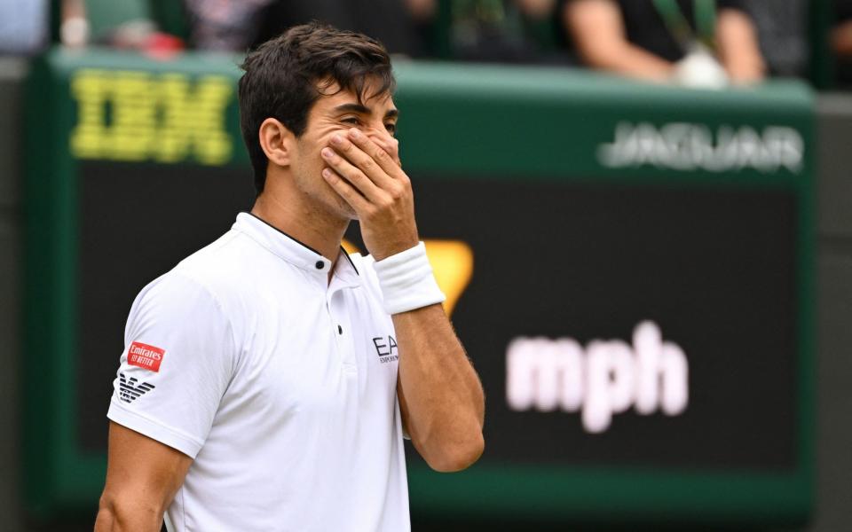 Chile's Cristian Garin reacts as he plays against Australia's Nick Kyrgios during their men's singles quarter final tennis match on the tenth day of the 2022 Wimbledon Championships at The All England Tennis Club in Wimbledon, southwest London, on July 6, 2022 - Sebastien Bozon/AFP