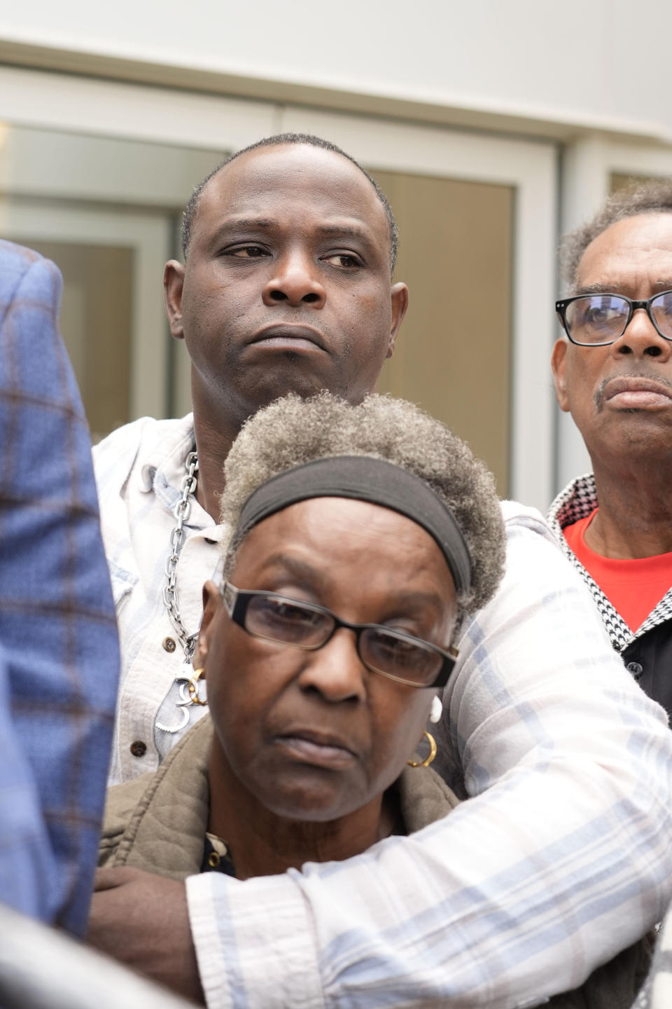 Eddie Terrell Parker and his aunt Linda Rawls listen as their civil attorney Malik Shabazz, unseen, speaks about the over 27 years in federal prison sentence given former Rankin County sheriff's deputy Brett McAlpin for his role in the racially motivated, violent torture of Parker and his friend Michael Corey Jenkins last year. (AP Photo/Rogelio V. Solis)