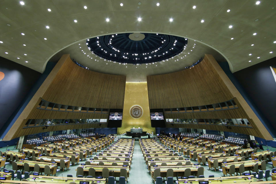 FILE - The United Nations General Assembly Hall sits empty before the start of the 76th Session of the General Assembly at U.N. headquarters on Sept. 20, 2021, in New York. Hong Kong government supporters have expanded their reach to defend a tough national security law imposed by China's ruling Communist Party at the United Nations, raising concerns over their influence on shaping the world's understanding of the city. (John Angelillo/Pool Photo via AP, File)