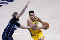 Indiana Pacers guard Malcolm Brogdon, right, goes around Orlando Magic guard Evan Fournier during the second half of an NBA basketball game in Indianapolis, Friday, Jan. 22, 2021. (AP Photo/AJ Mast)