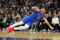 Dallas Mavericks guard Luka Doncic reacts after getting knocked to the ground during the first half of an NBA basketball game against the Phoenix Suns, Monday, Dec. 25, 2023, in Phoenix. (AP Photo/Rick Scuteri)