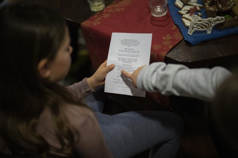 Members of the Polargospel, the children's choir at the only church in Svalbard, rehearse songs during their journey to Barentsburg, Norway, Saturday, Jan. 7, 2023. The choir traveled three hours each way by boat to mark Orthodox Christmas with the 40 children in Barentsburg, a village owned by Russia's Arctic mining company in the remote Norwegian territory. (AP Photo/Daniel Cole)