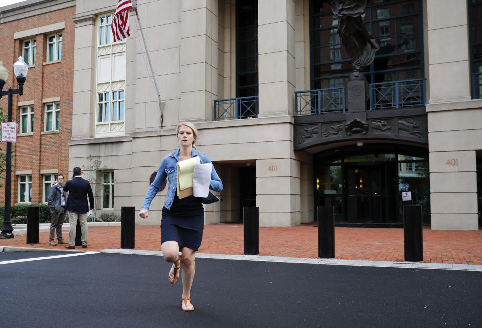 A member of the media runs with results outside of federal court as jury deliberations are announced in the trial of the former Donald Trump campaign chairman, in Alexandria, Va., Tuesday, Aug. 21, 2018. (AP Photo/Pablo Martinez Monsivais)