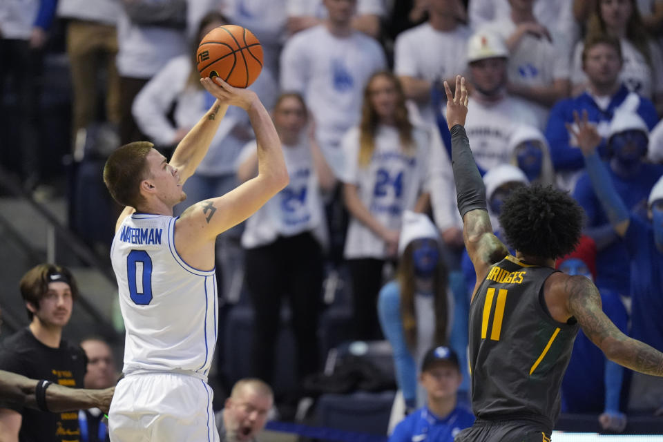 BYU forward Noah Waterman (0) shoots as Baylor forward Jalen Bridges (11) defends during the first half of an NCAA college basketball game Tuesday, Feb. 20, 2024, in Provo, Utah. (AP Photo/Rick Bowmer)