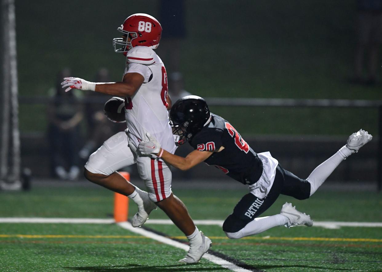 Fairport's Marques Garrett, left, beats Penfield's Anthony Fallon to the endzone for a touchdown during a regular season game, Friday, Sept. 1, 2023.