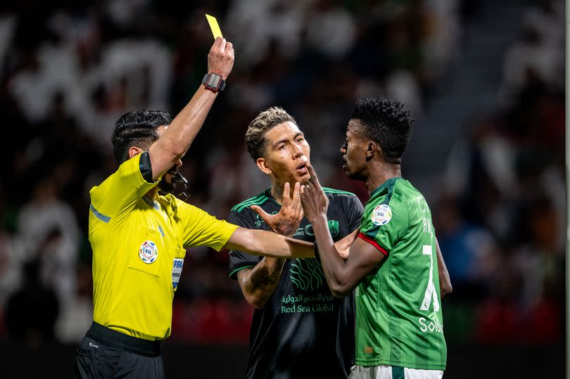 Roberto Firmino of Al-Ahli and Abdullah Khateeb of Al-Ettifaq react after the latest yellow card during the Saudi Pro League match between Al-Ettifaq and Al-Ahli SFC at Prince Mohamed bin Fahd Stadium on March 29, 2024 in Ad Dammam, Saudi Arabia.