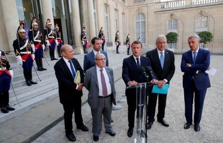 Le Drian, Vitorino, Castaner, Macron, Avramopoulos and Grandi deliver a joint statement at the Elysee Palace in Paris