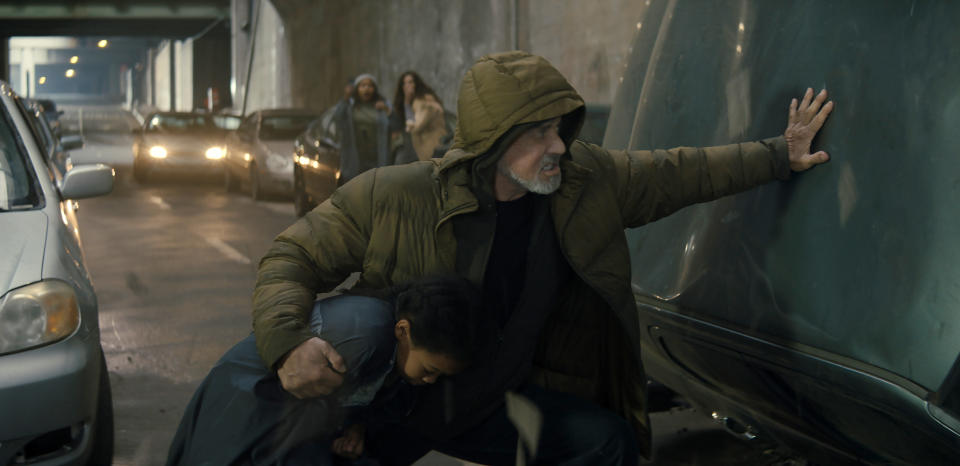 This image released by Metro Goldwyn Mayer Pictures shows Aria Seymore, left, and Sylvester Stallone in a scene from "Samaritan." (Metro Goldwyn Mayer Pictures via AP)