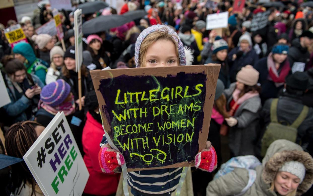 Orla Dean, 5, holds a placard during the Time's Up 2018 rally in London - Getty Images Europe