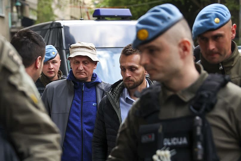 Members of the special police unit of Canton Sarajevo escort Vahidin Munjic, chief of the Federal Police, during an operation codenamed "Black Tie" in Sarajevo, Bosnia, Monday