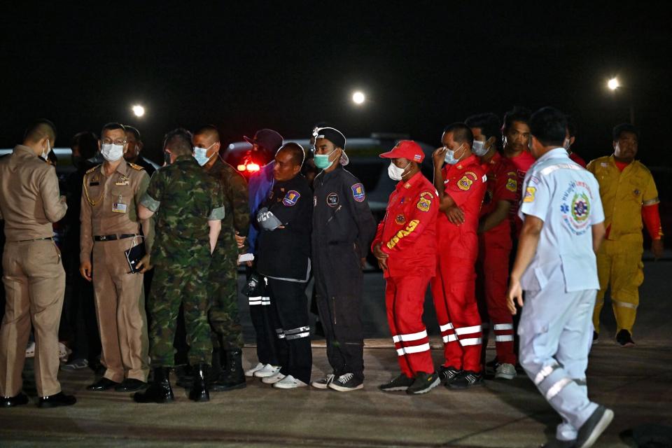 Army personnel and rescue crew gather at a makeshift rescue operation site during the search for survivors of the capsizing of the Thai naval vessel HTMS Sukhothai about 37 kilometres (22 miles) off the southeastern coast on Sunday night, at Bang Saphan Pier in Prachuap Khiri Khan district, on December 19, 2022. - Thai military frigates and helicopters were on December 19 searching for 31 sailors after a naval vessel sank, with dozens of others having been hauled from choppy waters.