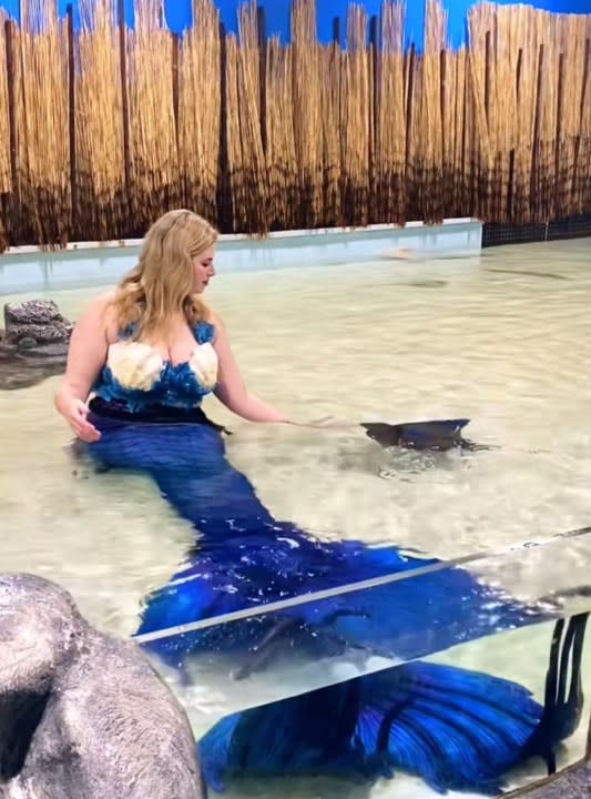<strong><em>Rose the Mermaid (Caroline Landreneau), swimming with stingrays. Photo courtesy of Jessica McQueen.</em></strong>