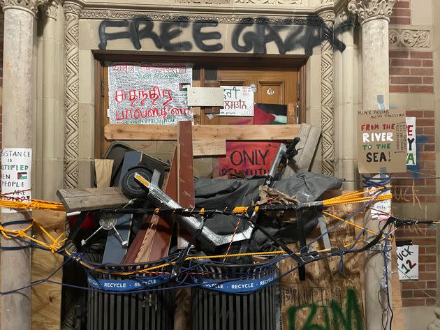 Pro-Palestinian protesters blocked the doors to Royce Hall on Wednesday night in anticipation of police intervention. Graffiti was painted on the building.