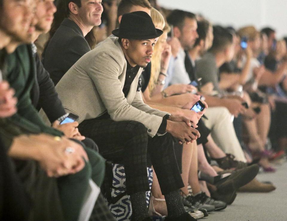 TV Personality Nick Cannon, center, host of "America's Got Talent," attends the Richard Chai Spring Summer 2014 collection on Thursday, Sept. 5, 2013 in New York. (AP Photo/Bebeto Matthews)