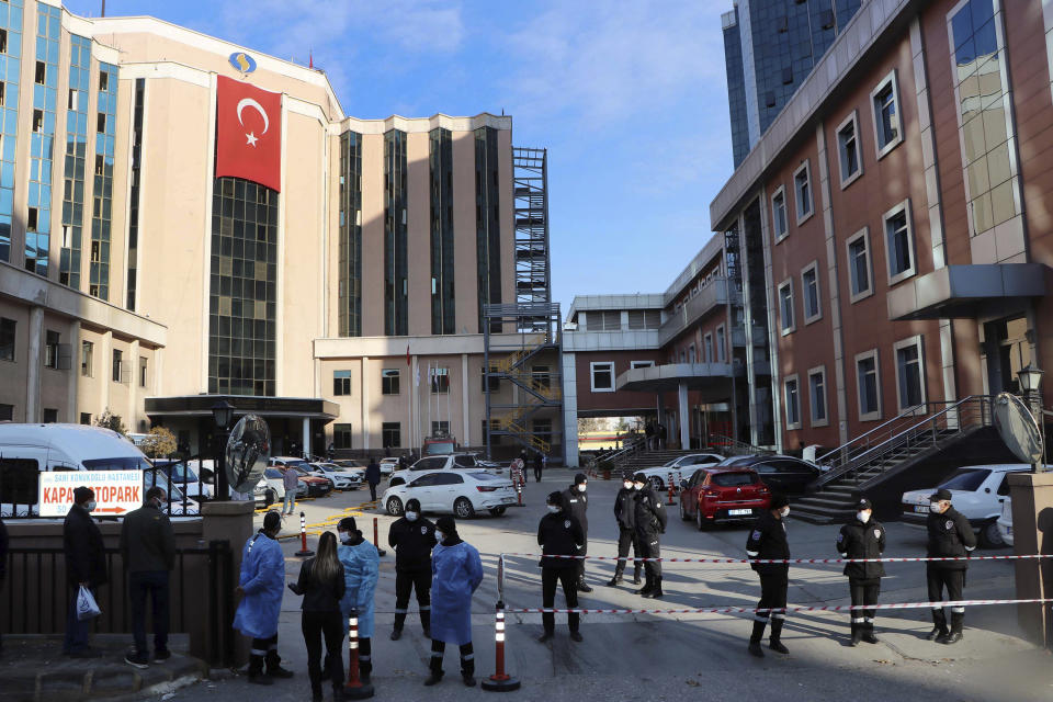 Police and medics gather outside the privately-run Sanko University Hospital in Gaziantep, southeastern Turkey, Saturday, De. 19, 2020. A fire broke out Saturday at an intensive care unit treating COVID-19 patients in southern Turkey after an oxygen cylinder exploded, killing several people, state-run media reported. (Kadir Gunes/DHA via AP)