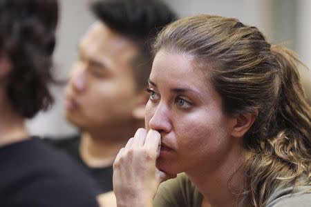 People listen to a speaker at a meeting of so-called "Liberty Kids" libertarian Republican activists in Burbank, California, July 27, 2014. REUTERS/David McNew