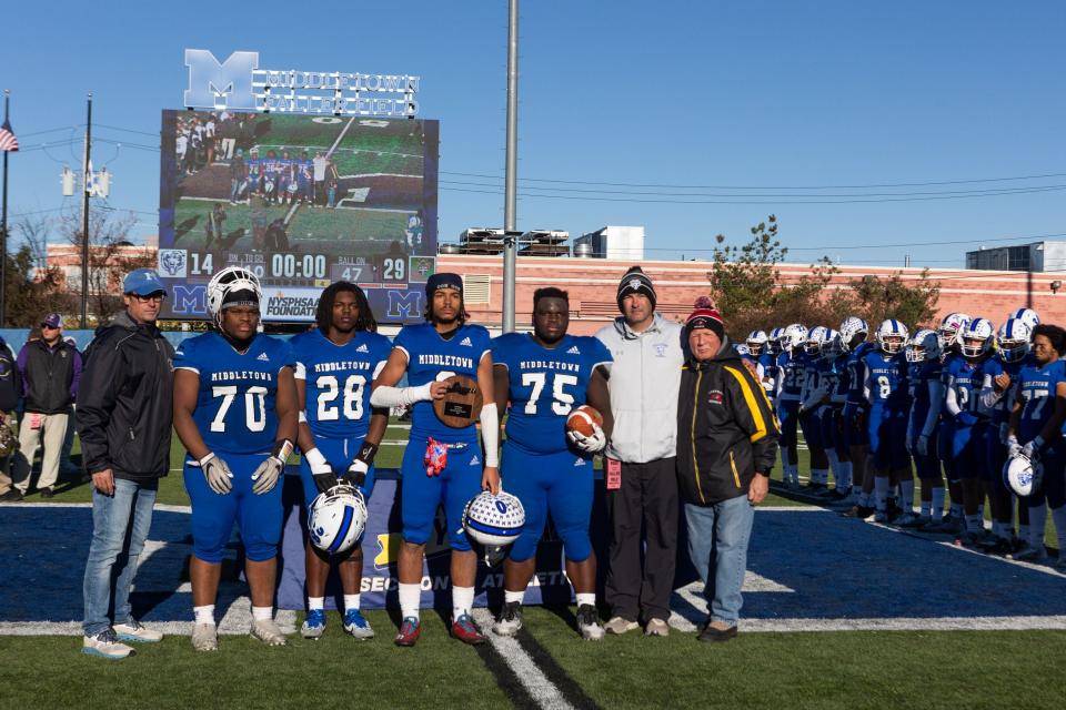 Middletown players pose with their runners up plaque in a Middletown vs Christian Brothers Academy of Albany game in Middletown, NY on November 18, 2023. ALLYSE PULLIAM/For the Times Herald-Record