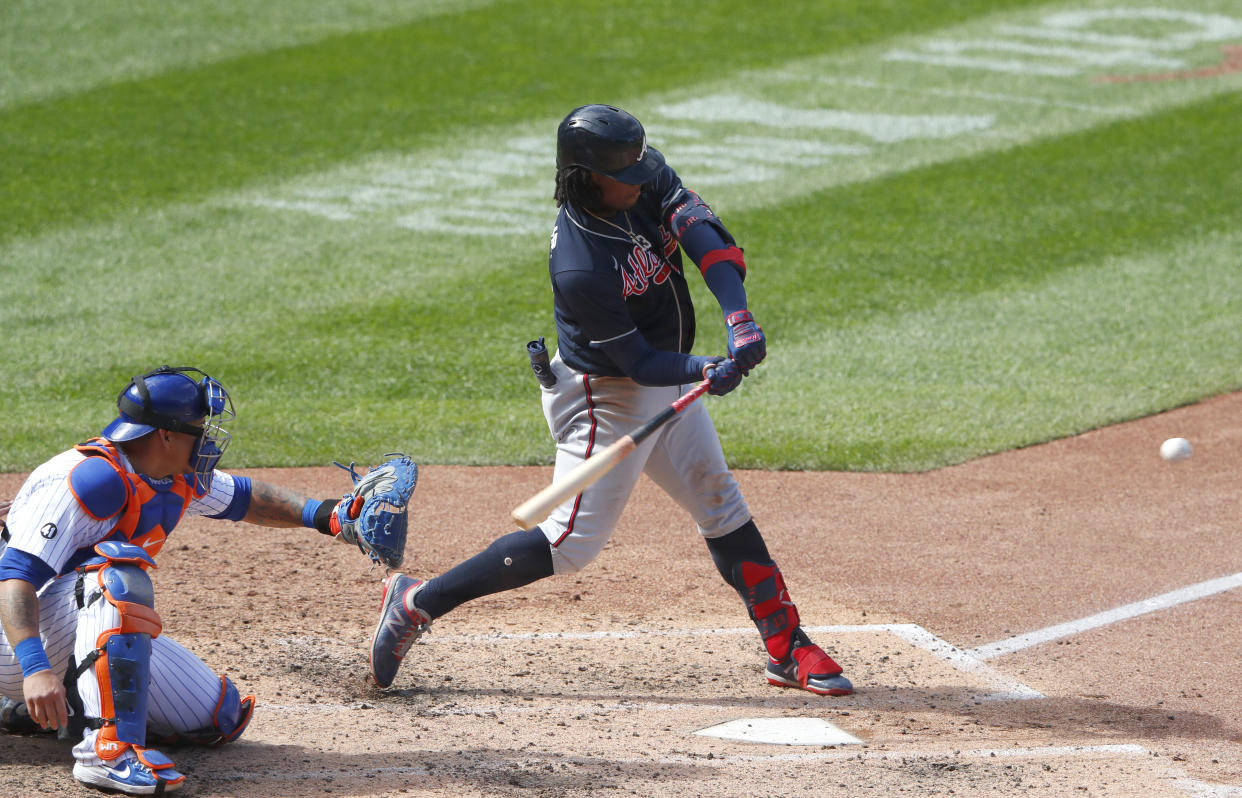 Atlanta Braves' Ronald Acuna Jr., right, hits a home run against the New York Mets during the sixth inning of a baseball game, Sunday, Sept. 20, 2020, in New York. (AP Photo/Noah K. Murray)