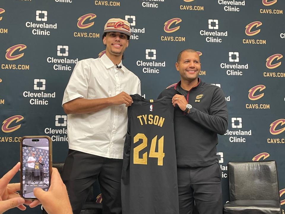 Cavaliers first-round draft pick Jaylon Tyson and president of basketball operations Koby Altman hold a jersey during Tyson's introductory news conference Thursday, June 27, in Independence.