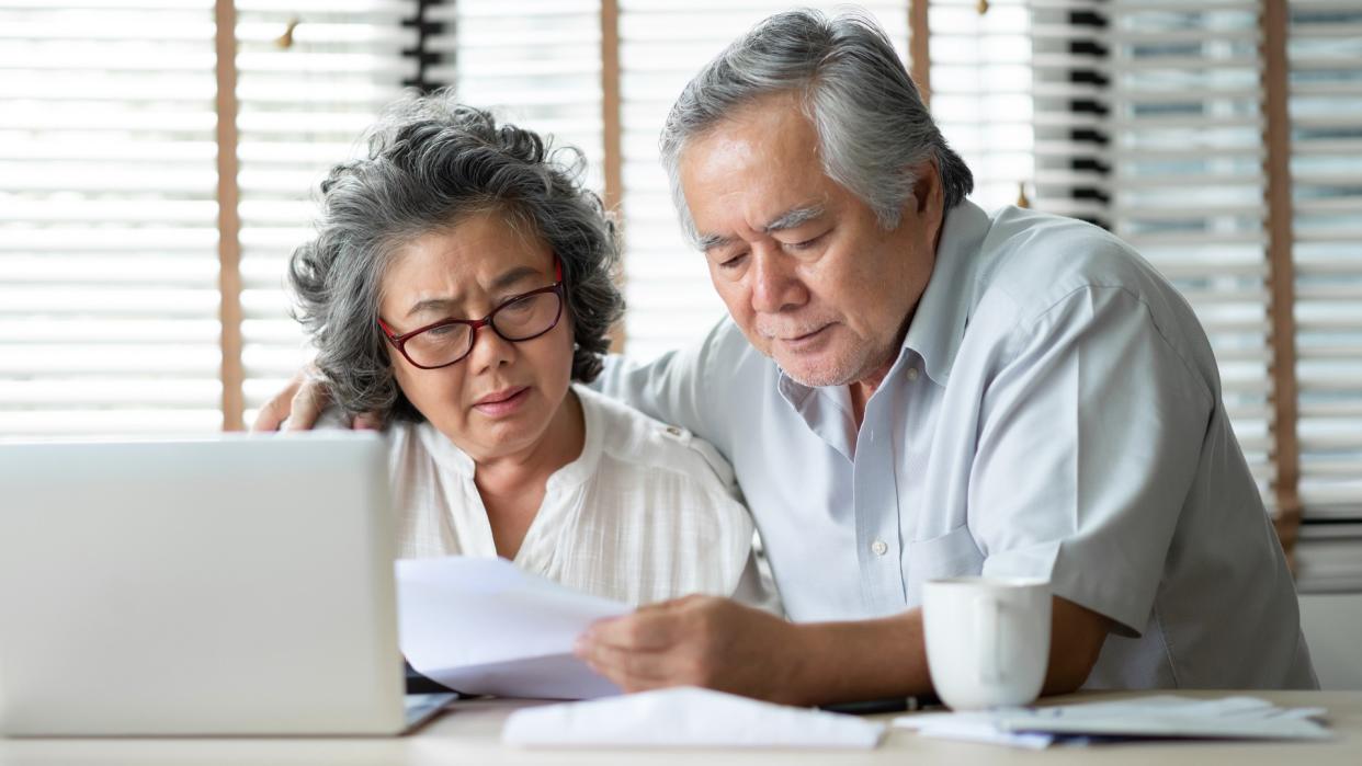 Stock image of retired couple looking a documents. (iStock)
