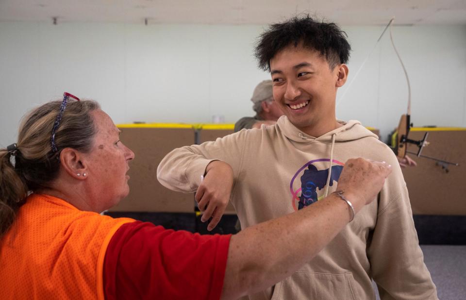 Michelle Murch, left, an instructor at the Washtenaw Sportsman's Club, helps Yifei Jiang, a student, with his aiming during the Hunter Safety Field Day in Ypsilanti on Saturday, Sept. 9, 2023.