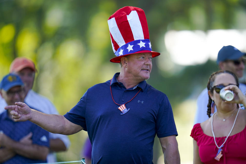 A fan watches Team USA during practice for the Presidents Cup golf tournament at the Quail Hollow Club, Wednesday, Sept. 21, 2022, in Charlotte, N.C. (AP Photo/Julio Cortez)