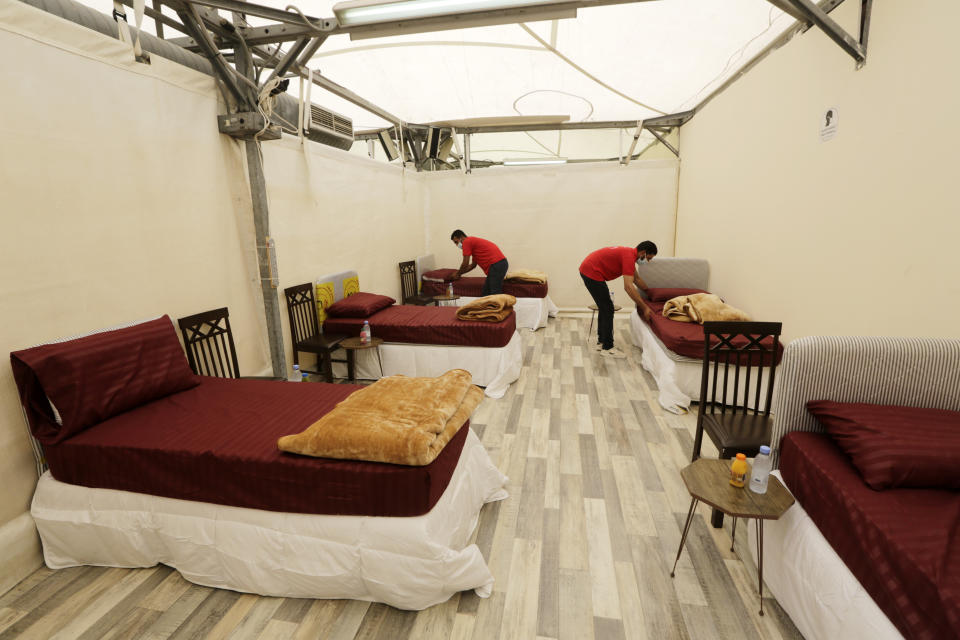 Workers set up accommodations for pilgrims at a tent camp in Mina, near the Muslim holy city of Mecca, ahead of the upcoming annual hajj pilgrimage, Monday, July 12, 2021. The pilgrimage to Mecca required once in a lifetime of every Muslim who can afford it and is physically able to make it, used to draw more than 2 million people. But for a second straight year it has been curtailed due to the coronavirus with only vaccinated people in Saudi Arabia able to participate. (AP Photo/Amr Nabil)