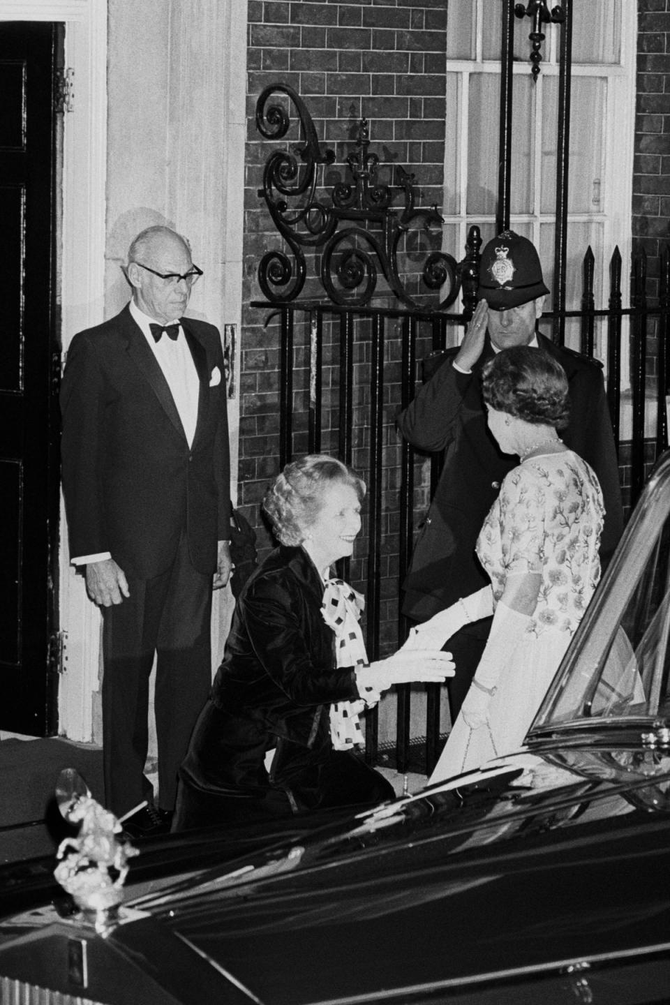 Margaret Thatcher curtseying to the Queen as she arrived for a dinner at 10 Downing Street in 1985 (PA) (PA Wire)