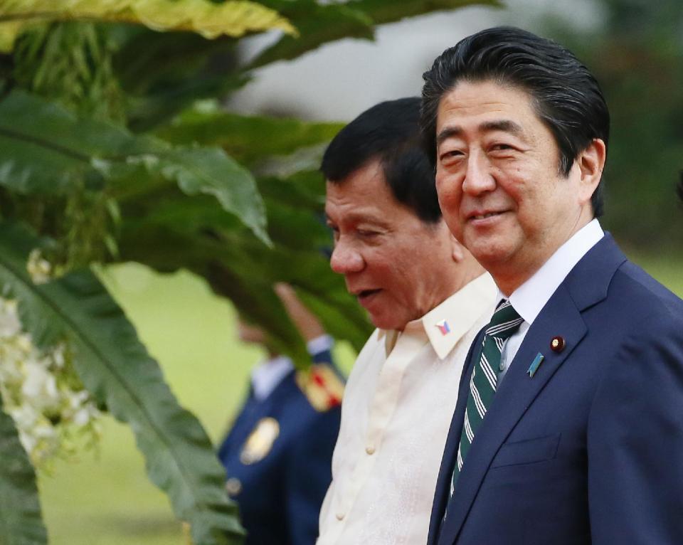 Japanese Prime Minister Shinzo Abe, right, and Philippine President Rodrigo Duterte walk together for their meeting at the Malacanang Palace grounds, Thursday, Jan. 12, 2017, in Manila, Philippines. Abe arrived Thursday for a two-day official visit that includes a visit to Duterte's hometown of Davao city in southern Philippines.(AP Photo/Bullit Marquez)