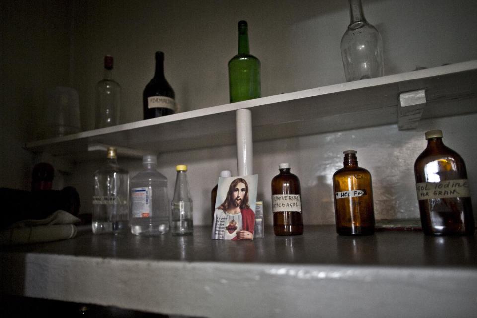 In this Saturday, Feb. 15, 2014, photo, a photograph of Jesus Christ is placed in a lab at St. Joseph’s Hospice, in Rawalpindi, Pakistan. Mohammed Aqeel spent weeks at home in Pakistan waiting for death after suffering a debilitating spinal cord injury in a car crash before friends suggested he come to St. Joseph’s Hospice on the outskirts of the capital, Islamabad. Now 13 years later, his life and those of some 40 others who live on its grounds might be changed forever as this hospital of last resort faces closure over its rising debts.(AP Photo/Muhammed Muheisen)