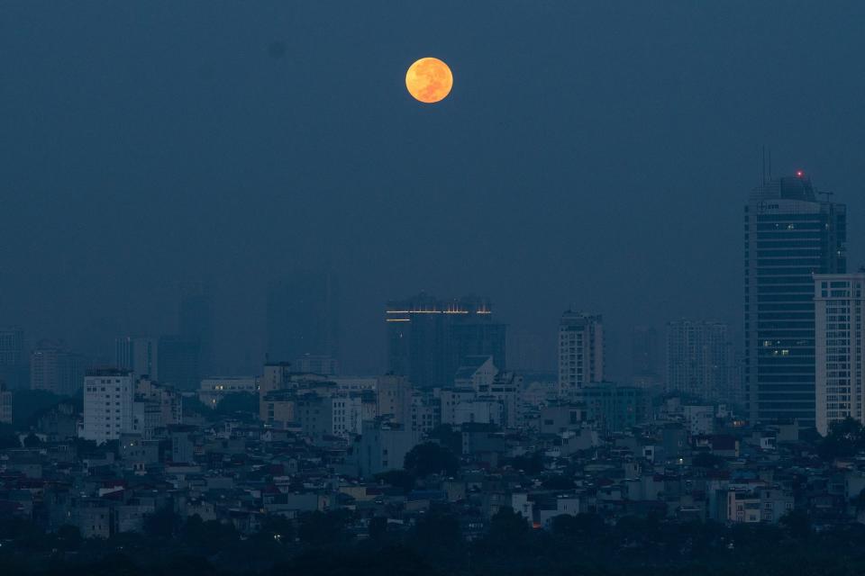 <p>The bright Harvest Moon was a bit more subdued over the skyline in Hanoi, Vietnam, at dawn.</p>