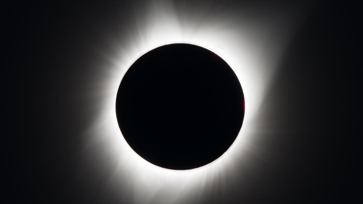  Closeup photo of the moon blocking the sun during a total solar eclipse. 