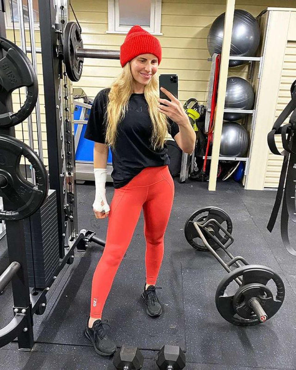 Tiffiny Hall wearing red leggings and a red beanie at the gym. Photo: Instagram/tiffhall_xo.