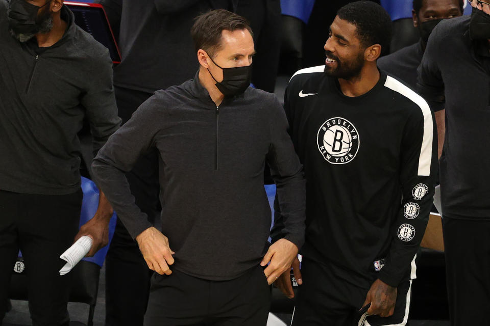 BOSTON, MASSACHUSETTS - DECEMBER 18: Brooklyn Nets head coach Steve Nash looks on with Kyrie Irving #11 of the Brooklyn Nets during the preseason game against the Boston Celtics at TD Garden on December 18, 2020 in Boston, Massachusetts. NOTE TO USER: User expressly acknowledges and agrees that, by downloading and or using this photograph, User is consenting to the terms and conditions of the Getty Images License Agreement.  (Photo by Maddie Meyer/Getty Images)