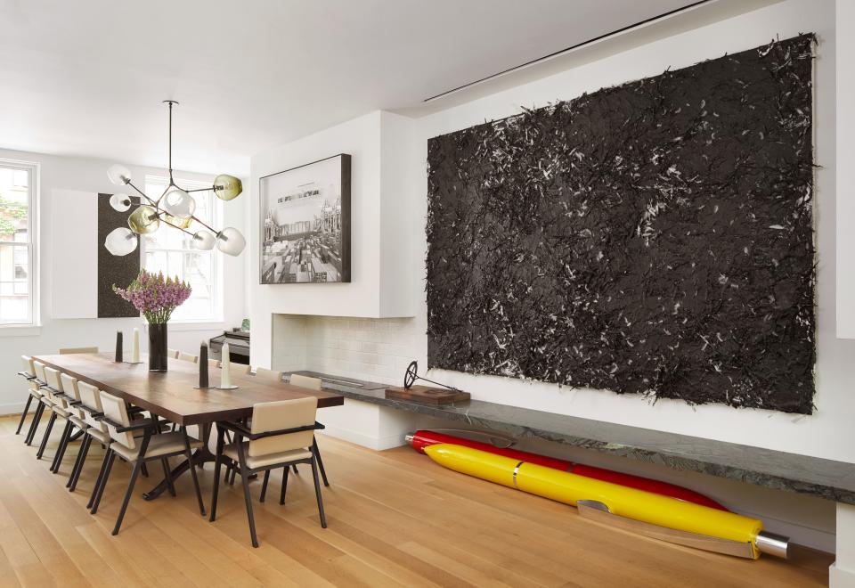 The formal dining room in a West Village townhouse owned by Marlies Verhoeven and her husband, Jacco Reijtenbagh—who brought on interior designer Kati Curtis to help define the spaces—is an honest expression of Verhoeven’s approach to design. The Cassina chairs around the Curtis-designed, BDDW-fabricated walnut slab table are some of the many items shipped in a container from Europe. The Lindsey Adelman fixture felt unexpected at the time, but Verhoeven, cofounder and CEO of global arts club the Cultivist, says, “Now I see it in quite a few houses, which makes me cringe a little bit. I still adore it, but it’s definitely gotten way more popular than it used to be.” Artwork by Dan Colen, Johannes Albers (whose pens show they don’t take themselves too seriously), Mary Corse, and JR (whom Verhoeven became quite interested in after a Cultivist studio visit) completes the space.