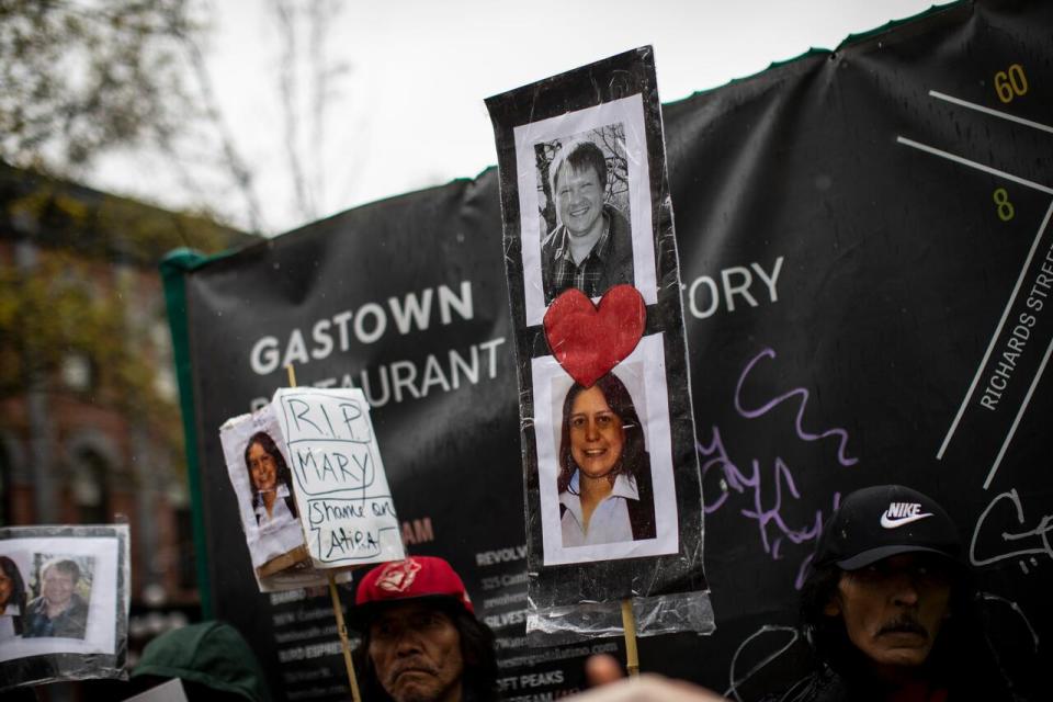 People in the march commemorating late Dennis Guay and Mary Ann Garlow who were found dead in the aftermath of the fire at the hotel, which was later demolished.