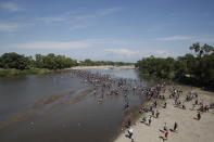 Central American migrants cross the Suchiate River by foot from Tecun Uman, Guatemala, to Mexico, Monday, Jan. 20, 2020. More than a thousand Central American migrants hoping to reach United States marooned in Guatemala are walking en masse across a river leading to Mexico in an attempt to convince authorities there to allow them passage through the country. (AP Photo/Moises Castillo)