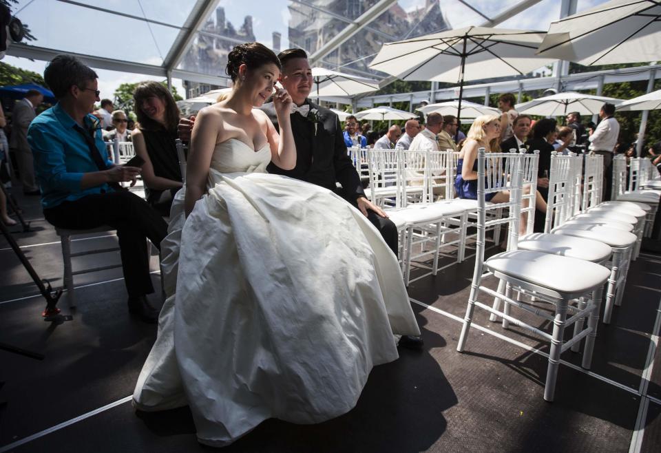 Murphy and St. Germain sit before the ceremony for "The Celebration of Love", a grand wedding where over 100 LGBT couples got married, at Casa Loma in Toronto