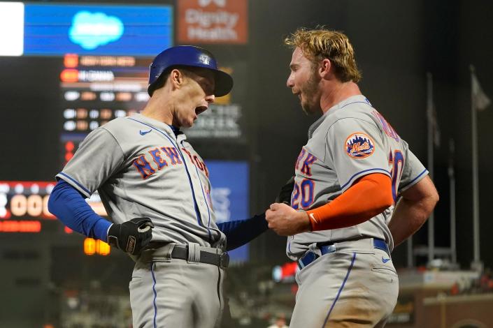 New York Mets' Mark Canha, left, is congratulated by Pete Alonso after hitting a home run against the San Francisco Giants during the eighth inning of a baseball game in San Francisco, Monday, May 23, 2022.