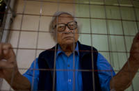 In this Oct. 24, 2013 photo, Win Tin, a former political prisoner and an opposition party stalwart poses for a picture at his home in Yangon, Myanmar. Win Tin, a prominent journalist who became Myanmar's longest-serving political prisoner after challenging military rule by co-founding the National League for Democracy has died. He was 85. He died of renal failure Monday morning, April 21, 2014, family said. (AP Photo/Gemunu Amarasinghe)